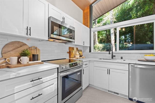 18265 47th Pl NE, Lake Forest Park, WA 98155 - kitchen featuring stainless steel appliances, backsplash, white cabinets, and light stone counters