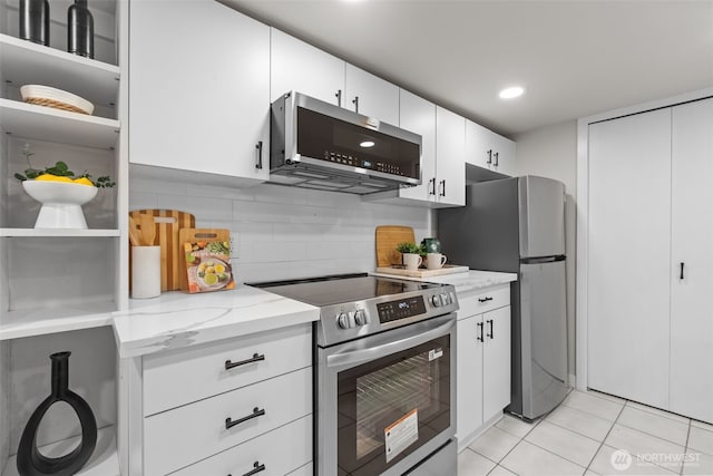 18265 47th Pl NE, Lake Forest Park, WA 98155 - kitchen with appliances with stainless steel finishes, light stone counters, decorative backsplash, light tile patterned flooring, and white cabinetry