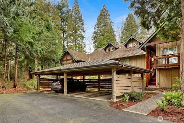 exterior space featuring aphalt driveway and a carport