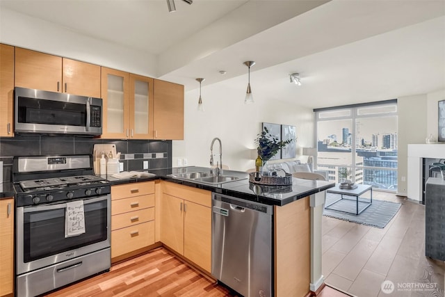 819 Virginia St Unit 3006, Seattle, WA 98101 - kitchen featuring a sink, a peninsula, open floor plan, and stainless steel appliances