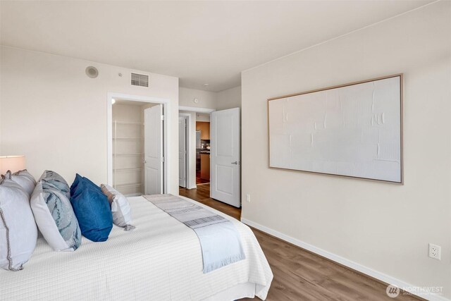 819 Virginia St Unit 3006, Seattle, WA 98101 - bedroom featuring visible vents, wood finished floors, baseboards, and a spacious closet