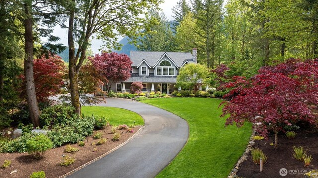 46707 SE 156th Pl, North Bend, WA 98045 - new england style home with a front lawn, a chimney, and curved driveway