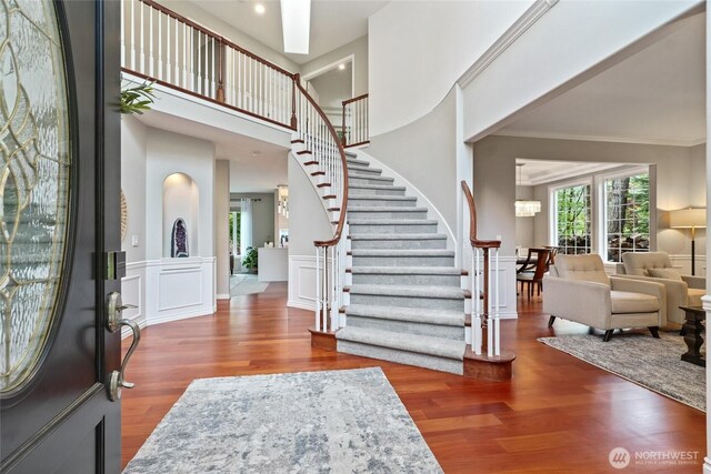 46707 SE 156th Pl, North Bend, WA 98045 - foyer entrance featuring wood finished floors, stairway, crown molding, a high ceiling, and a wainscoted wall