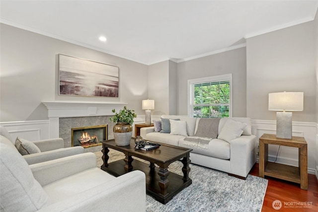 46707 SE 156th Pl, North Bend, WA 98045 - living area with wood finished floors, crown molding, wainscoting, a high end fireplace, and recessed lighting