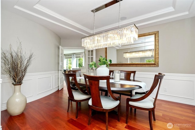 46707 SE 156th Pl, North Bend, WA 98045 - dining area with a chandelier, a tray ceiling, wood finished floors, wainscoting, and ornamental molding