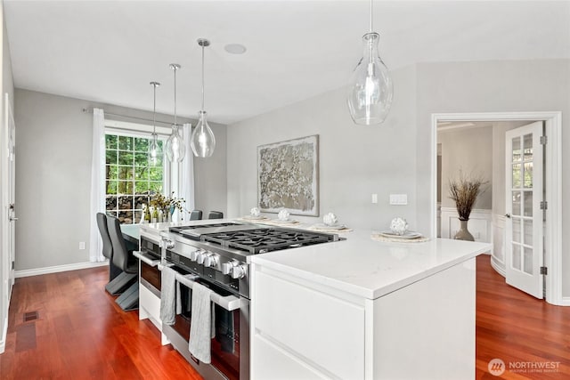 46707 SE 156th Pl, North Bend, WA 98045 - kitchen featuring stainless steel range, dark wood-style flooring, white cabinetry, light countertops, and decorative light fixtures