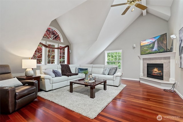 46707 SE 156th Pl, North Bend, WA 98045 - living area with wood finished floors, a ceiling fan, a tile fireplace, baseboards, and high vaulted ceiling