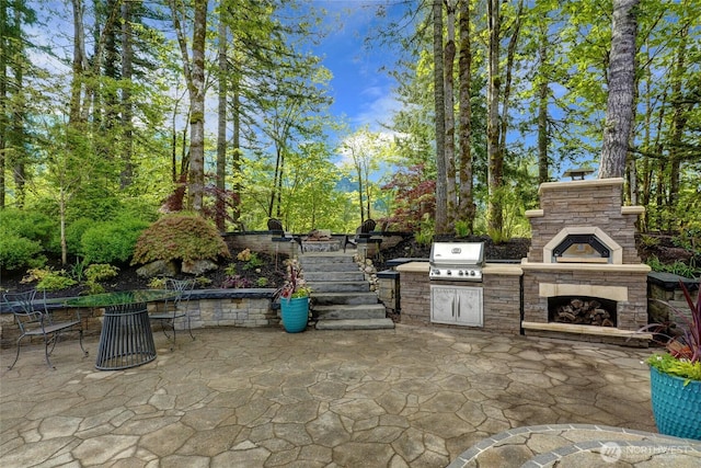 46707 SE 156th Pl, North Bend, WA 98045 - view of patio / terrace with area for grilling, an outdoor stone fireplace, and stairway