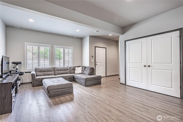 living room featuring light wood-style floors, recessed lighting, and visible vents