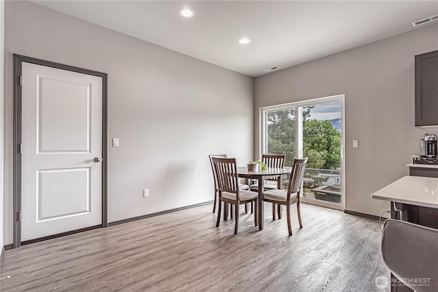 dining room featuring recessed lighting, baseboards, visible vents, and light wood-type flooring