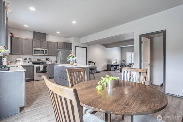dining area featuring recessed lighting and light wood-style flooring