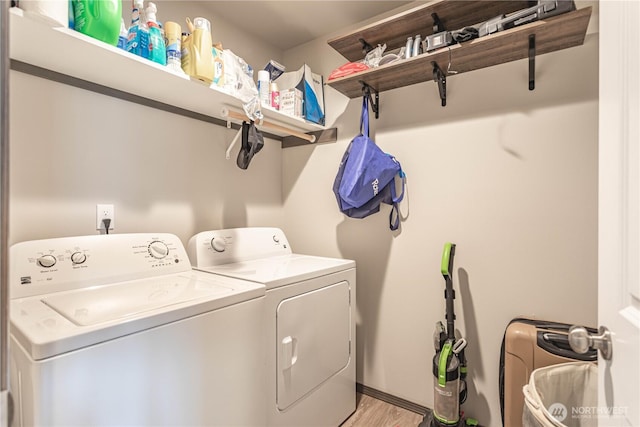 laundry area with laundry area, light wood-style flooring, and washing machine and clothes dryer