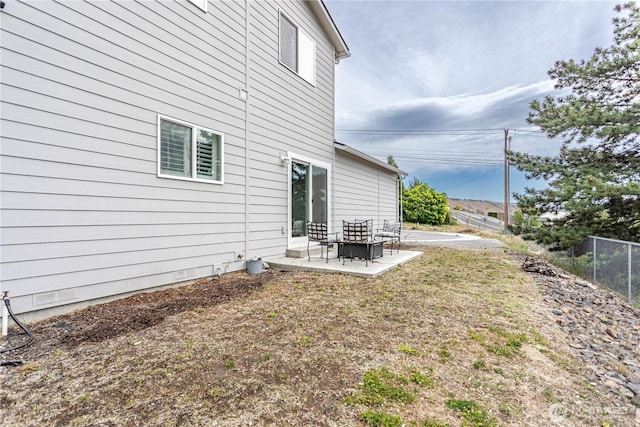 back of property featuring a patio and fence