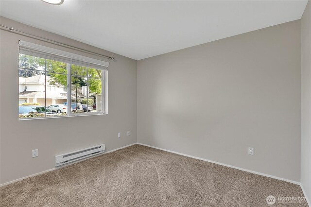 carpeted empty room featuring baseboards and a baseboard radiator