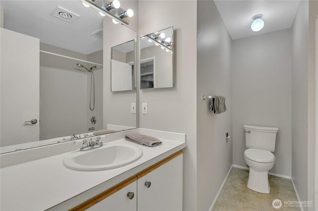 full bath with visible vents, vanity, a shower, toilet, and baseboards