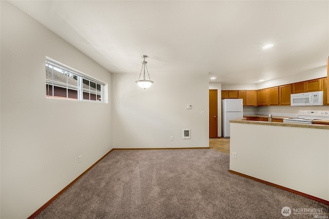 kitchen featuring brown cabinets, baseboards, light carpet, recessed lighting, and white appliances