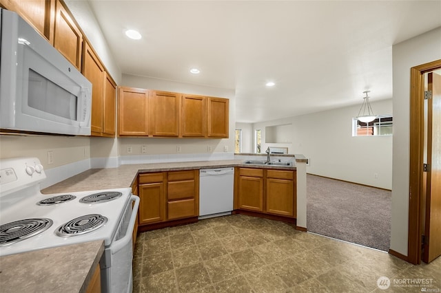 kitchen with white appliances, recessed lighting, open floor plan, and a sink