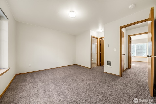 interior space featuring baseboards, carpet flooring, and visible vents
