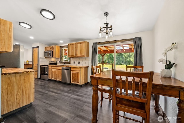 104 Ridge View Dr, Randle, WA 98377 - kitchen with appliances with stainless steel finishes, butcher block countertops, dark wood finished floors, a sink, and backsplash