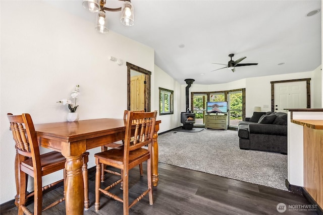 104 Ridge View Dr, Randle, WA 98377 - dining area featuring a wood stove, a ceiling fan, lofted ceiling, dark wood-style floors, and baseboards