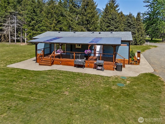 104 Ridge View Dr, Randle, WA 98377 - rear view of property with a yard, a wooden deck, and a patio
