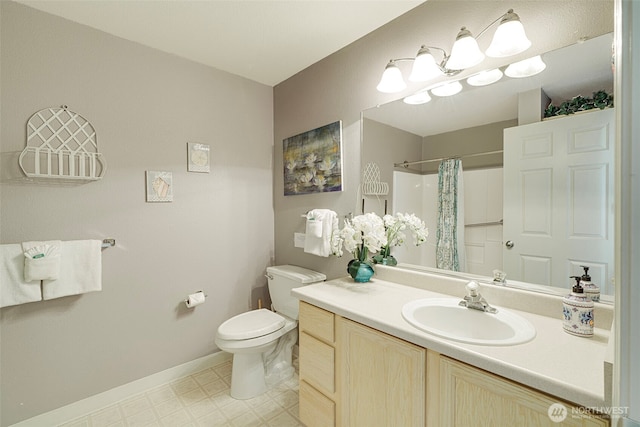 501 Shoreview Dr S Unit 204, Long Beach, WA 98631 - bathroom featuring toilet, vanity, curtained shower, tile patterned floors, and baseboards