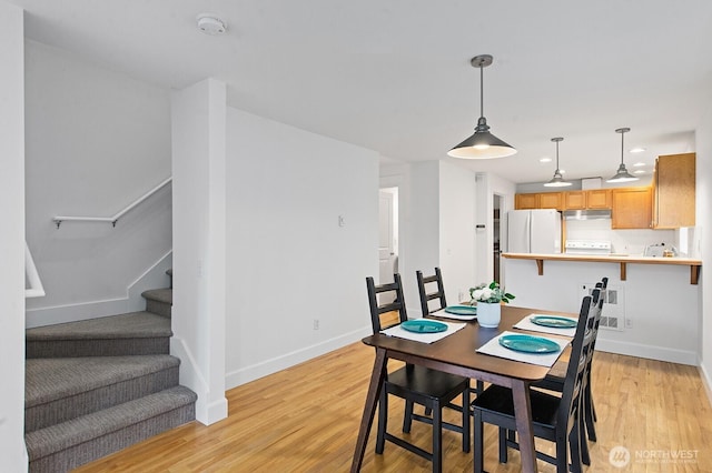 dining area with stairs, recessed lighting, baseboards, and light wood-style flooring