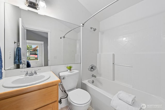 bathroom with toilet, bathing tub / shower combination, and vanity