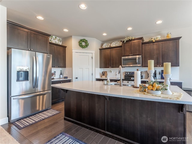 1974 Legendary Ln SE, East Wenatchee, WA 98802 - kitchen featuring stainless steel appliances, dark brown cabinets, a large island with sink, dark wood-type flooring, and recessed lighting