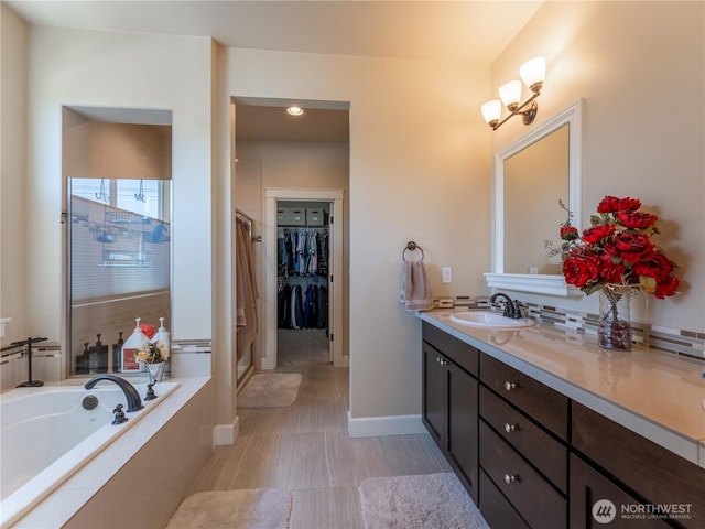 1974 Legendary Ln SE, East Wenatchee, WA 98802 - full bath with a shower stall, vanity, a garden tub, a walk in closet, and baseboards