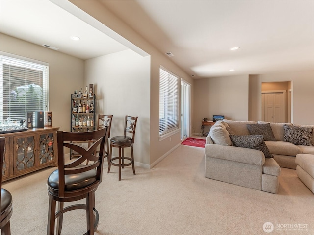 1974 Legendary Ln SE, East Wenatchee, WA 98802 - carpeted living area with plenty of natural light, a bar, baseboards, and recessed lighting