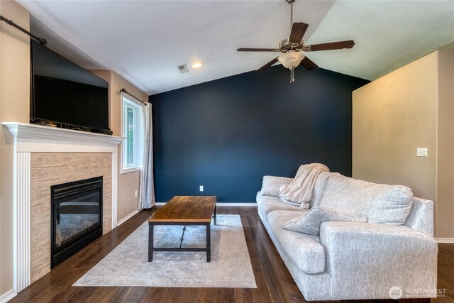 301 NE Danner Ln, College Place, WA 99324 - living room featuring a ceiling fan, visible vents, lofted ceiling, a glass covered fireplace, and dark wood-type flooring