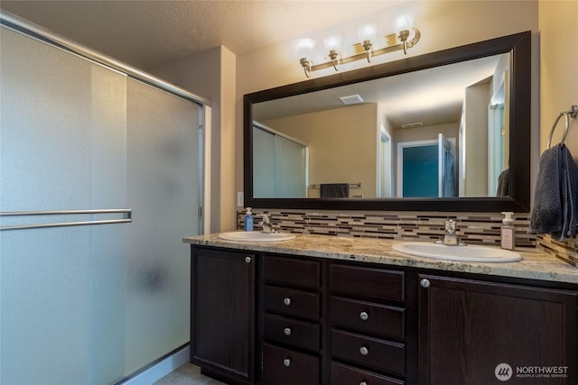 301 NE Danner Ln, College Place, WA 99324 - bathroom with a sink, backsplash, a stall shower, and double vanity
