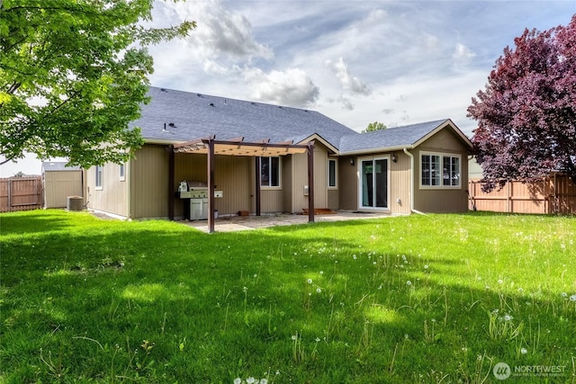 301 NE Danner Ln, College Place, WA 99324 - rear view of house with a shingled roof, a patio area, fence, and a yard