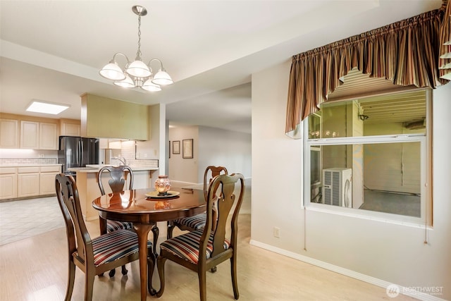 2506 SE Baypoint Dr Unit L45, Vancouver, WA 98683 - dining space with baseboards, a notable chandelier, and light wood-style flooring