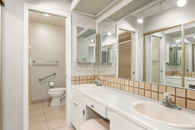 2506 SE Baypoint Dr Unit L45, Vancouver, WA 98683 - full bath with double vanity, a sink, tile patterned floors, and toilet