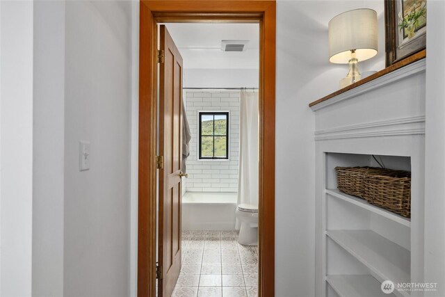 hallway with light tile patterned floors