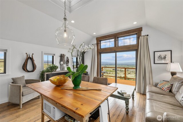 dining area featuring plenty of natural light, recessed lighting, light wood finished floors, and vaulted ceiling