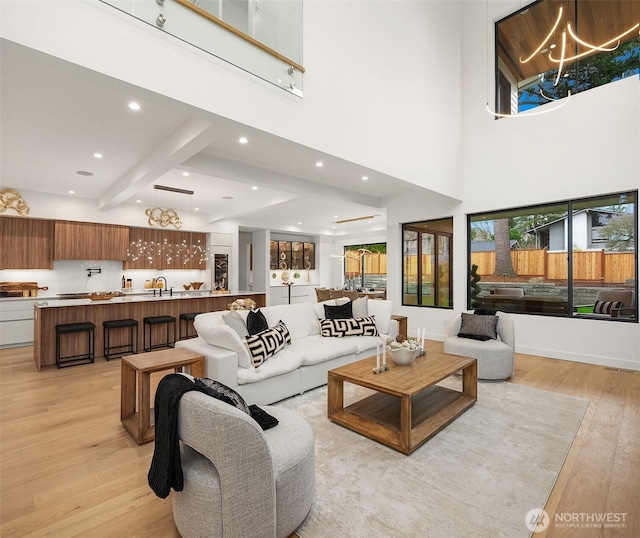 422 98th Ave NE, Bellevue, WA 98004 - living area with a notable chandelier, light wood-style flooring, recessed lighting, a towering ceiling, and beamed ceiling