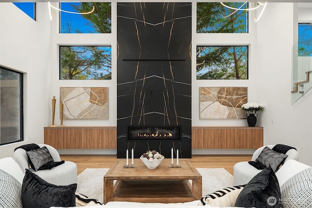 422 98th Ave NE, Bellevue, WA 98004 - living area with a high ceiling, wood finished floors, stairway, and a fireplace