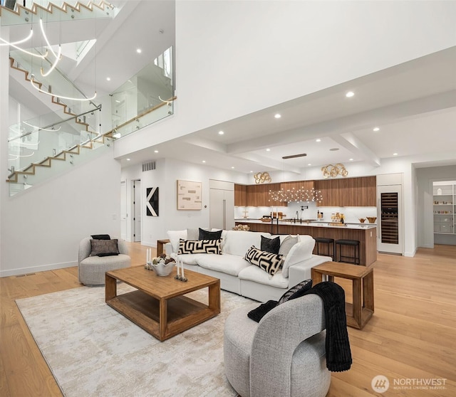 422 98th Ave NE, Bellevue, WA 98004 - living area with light wood finished floors, beverage cooler, baseboards, visible vents, and stairway