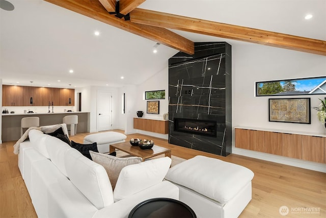 422 98th Ave NE, Bellevue, WA 98004 - living area featuring light wood finished floors, high vaulted ceiling, a large fireplace, recessed lighting, and beamed ceiling