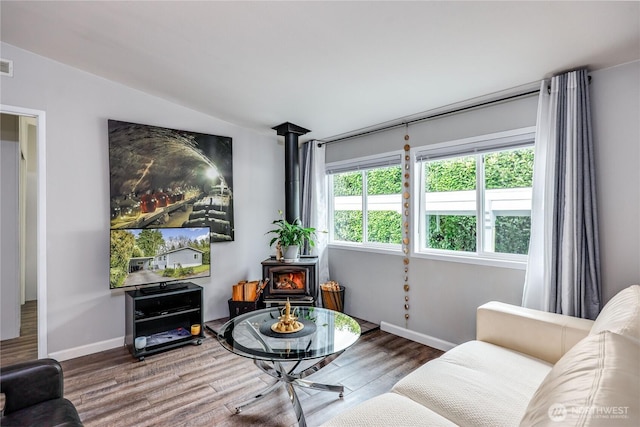 8760 State Highway 303 NE Unit C, Bremerton, WA 98311 - living room with baseboards, visible vents, wood finished floors, and a wood stove