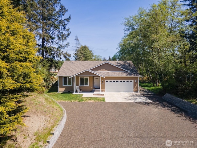 464 Dolphin Ave NE, Ocean Shores, WA 98569 - view of front facade featuring a garage and concrete driveway