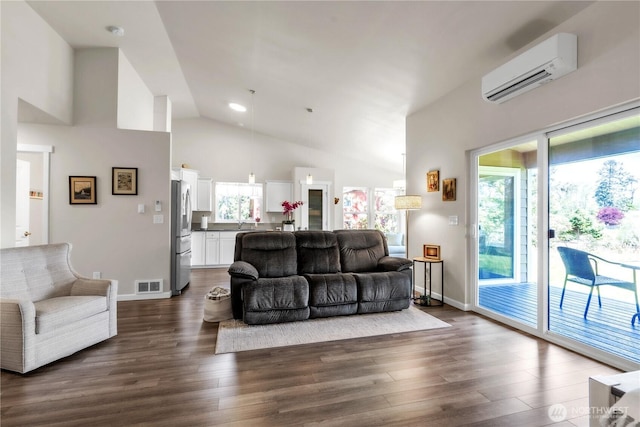 464 Dolphin Ave NE, Ocean Shores, WA 98569 - living area featuring visible vents, dark wood-style floors, a wealth of natural light, and a wall mounted air conditioner