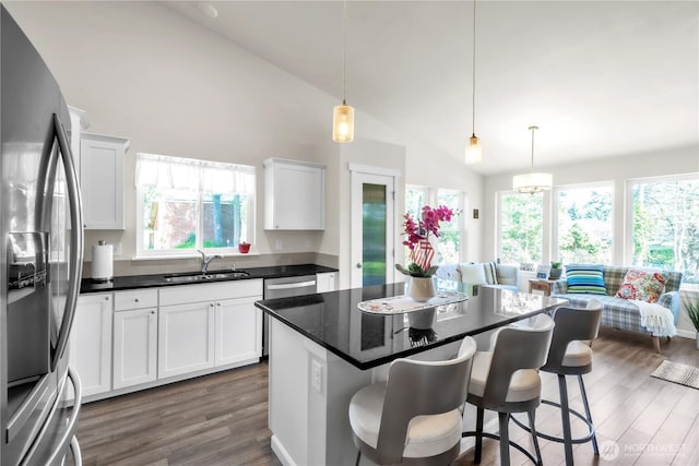 464 Dolphin Ave NE, Ocean Shores, WA 98569 - kitchen with a sink, appliances with stainless steel finishes, a healthy amount of sunlight, and a breakfast bar