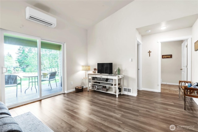 464 Dolphin Ave NE, Ocean Shores, WA 98569 - living room featuring an AC wall unit, baseboards, visible vents, and wood finished floors