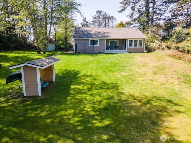 464 Dolphin Ave NE, Ocean Shores, WA 98569 - rear view of house featuring a yard, an outdoor structure, and a shed