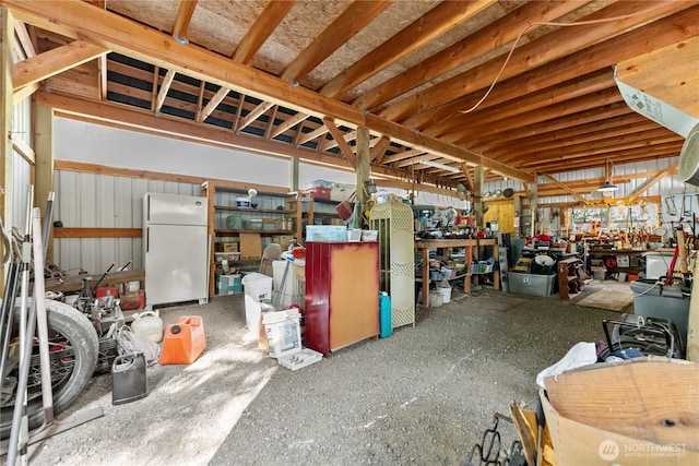 43 Arnica Ln, Twisp, WA 98856 - garage with freestanding refrigerator and a workshop area