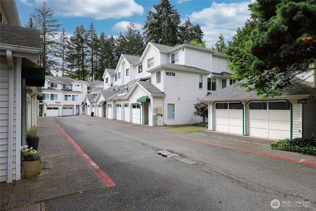 view of street featuring a residential view and community garages